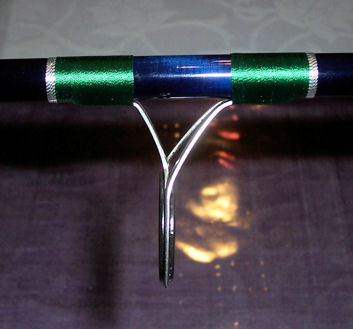 Guide is wrapped with green thread an silver decorative wrapping.